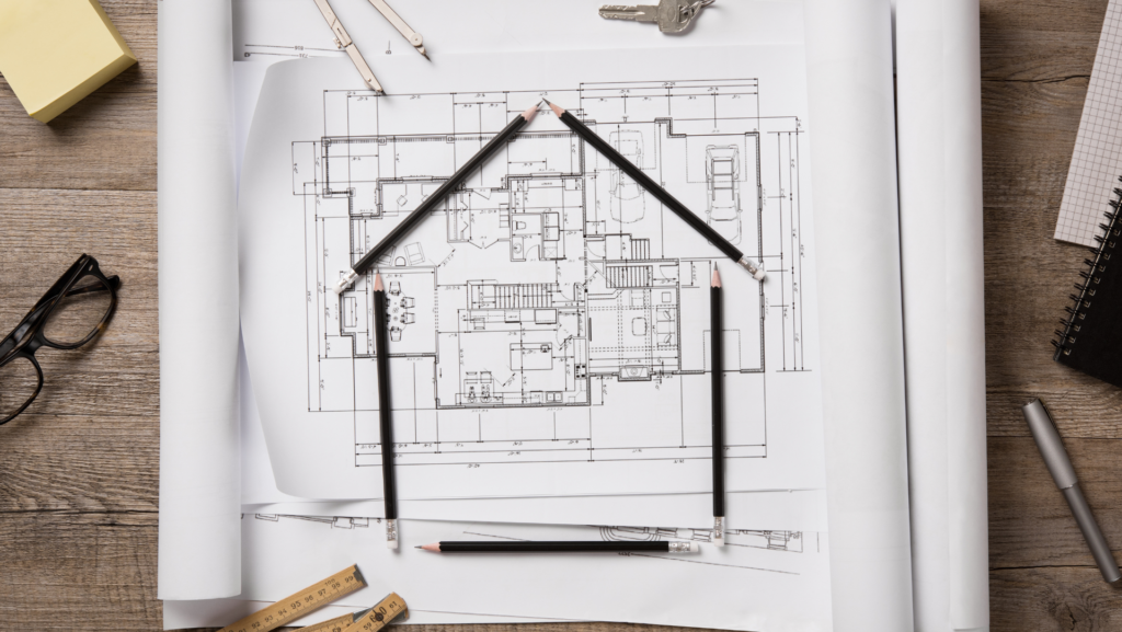 a house plan with pencils and ruler